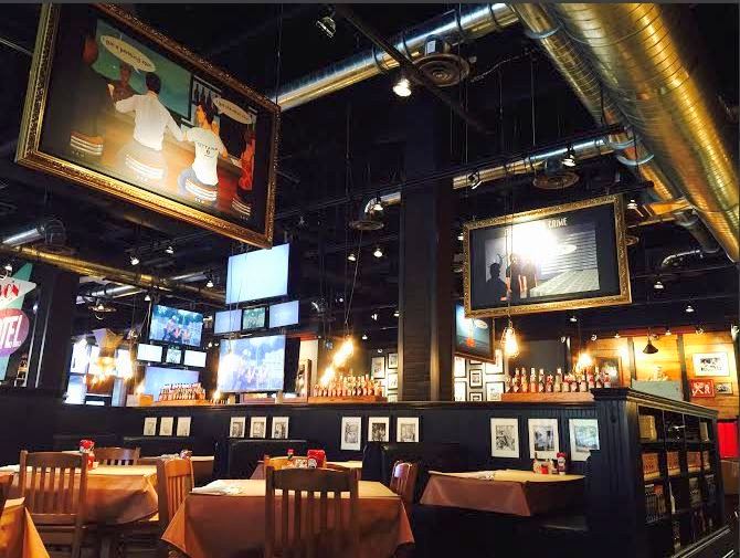 The inside of a restaurant with a lot of framed pictures.