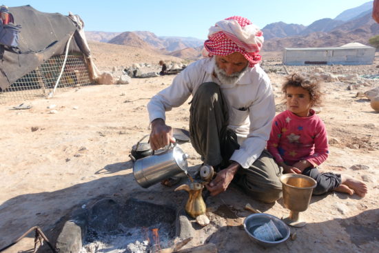 Local Bedouin and daughter making Arabic Coffee