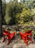 cropped two orange chairs with lake
